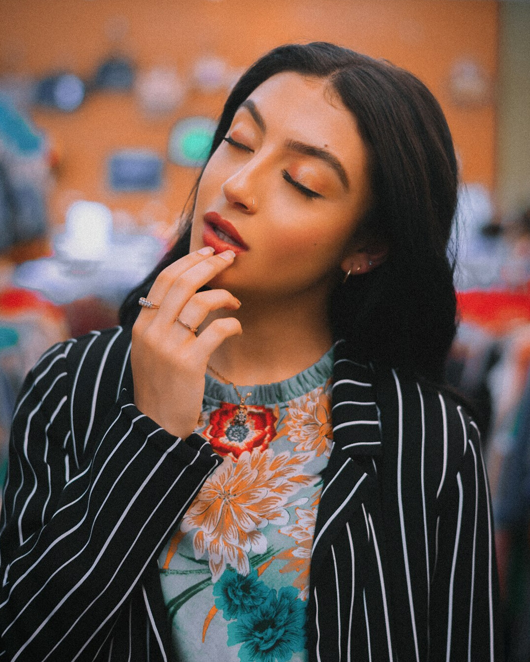 Portrait of a British woman with dark hair, smiling, in a business casual blazer