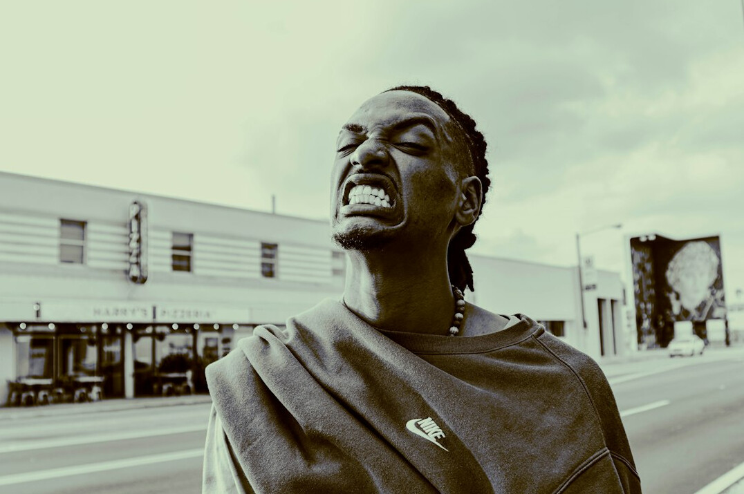 Portrait of a Black British man in a smart jumper smiling
